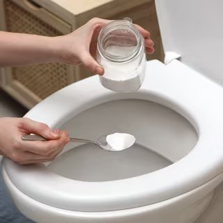 Le bicarbonate de soude associé au vinaigre blanc peut s'avérer efficace pour déboucher des toilettes. ©New Africa, Adobe Stock